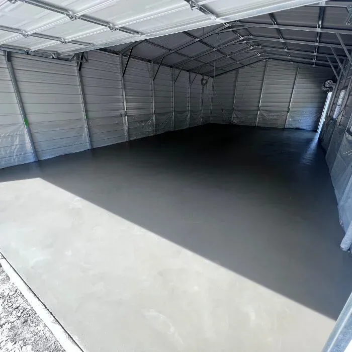 Sealed gray concrete floor inside a metal pole building