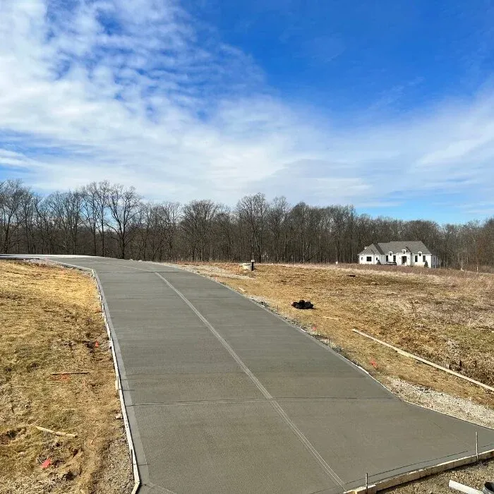 Long curved concrete driveway at a newly built home